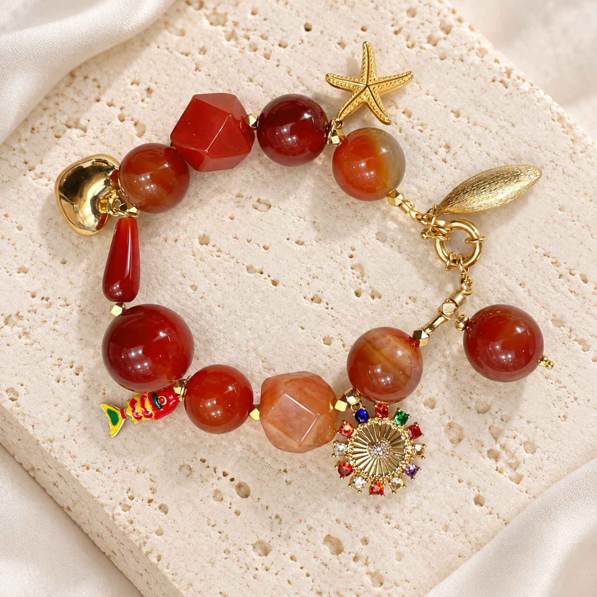 Sunset Agate Charm Bracelet — full bracelet on a cream stone surface